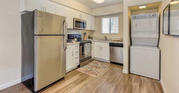 Kitchen with stainless steel appliances and white cabinets  at Silverstone Apartments, Davis