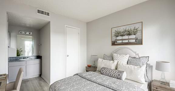 A bedroom with a large bed and a painting on the wall.