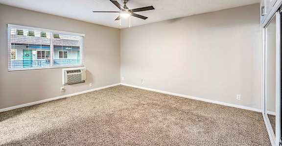 The Island Apartments unfurnished bedroom with ceiling fan