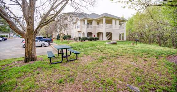 a house with a picnic table in front of it