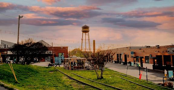 a city street with a water tower in the middle of it
