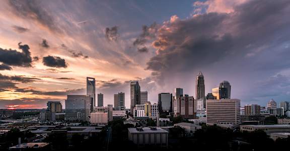 the skyline of the city at sunset