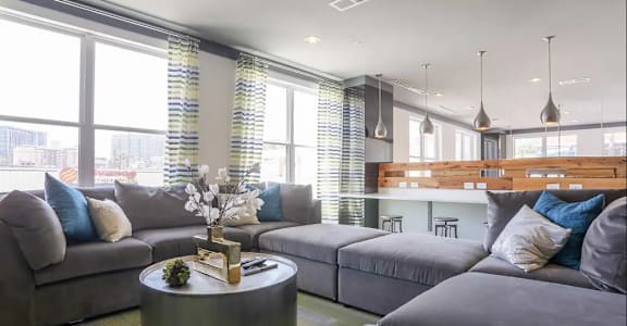 a living room filled with furniture and a large window