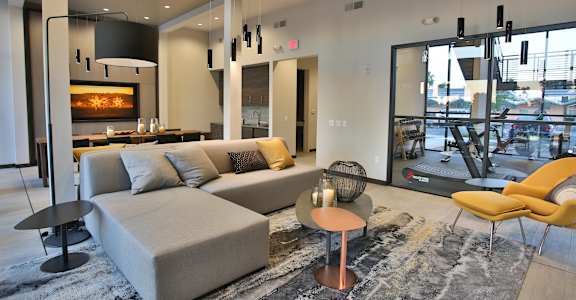 a living room with a couch and chairs and a fireplace