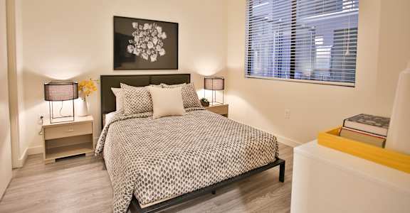 a bedroom with a bed and a window