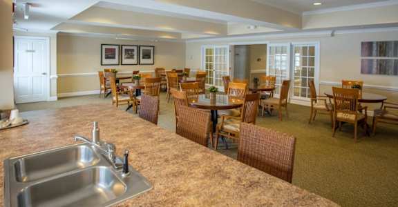 a large room with a long counter and chairs