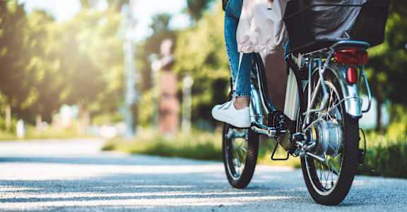 a person riding a bike down a street