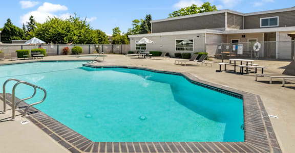 our apartments have a resort style pool with chairs and tables