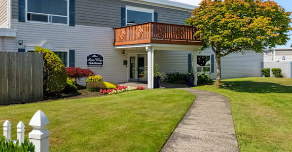 a house with a walkway leading to the front door