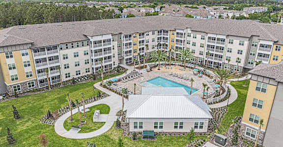 an aerial view of an apartment complex with a pool and a courtyard