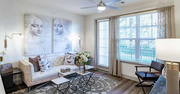 white sofa with brown pillows at Alys Crossing Apartments, Cypress