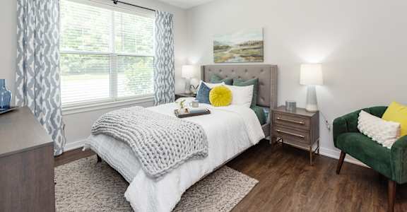 Bedroom with bed, lamp at Lumen, Hampton, VA