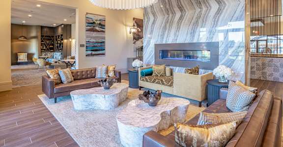 A living room with a brown couch and a white coffee table at Stone Loch Apartments, Tomball