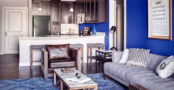 A living room with a grey couch and a coffee table at Waterstone at Hamburg Apartments, KY 40509