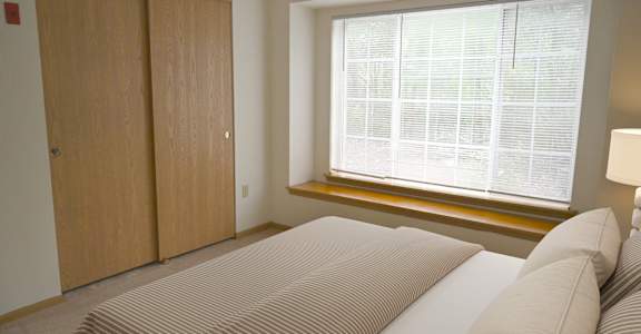 a bedroom with a large bed and a window