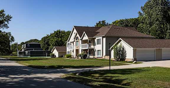 a row of houses in a neighborhood with a basketball court