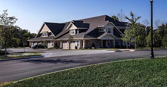 a large house on a street corner with a street light