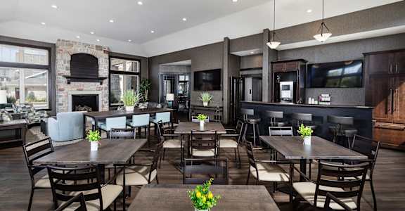 a large dining room with tables and chairs and a fireplace