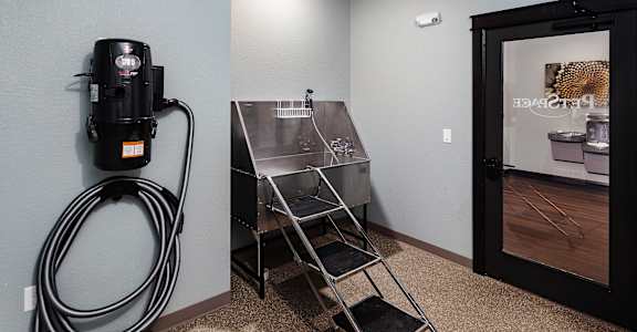 a utility room with a coffee machine and a stainless steel sink