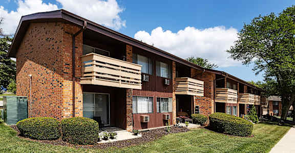 a brick apartment building with wooden balconies
