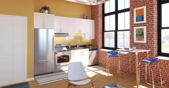 A kitchen with a refrigerator, oven, and bar stools.
