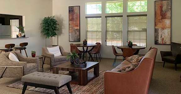 Community room with seating and windows at COURTYARDS @ PENN VALLEY, PENN VALLEY, CA 