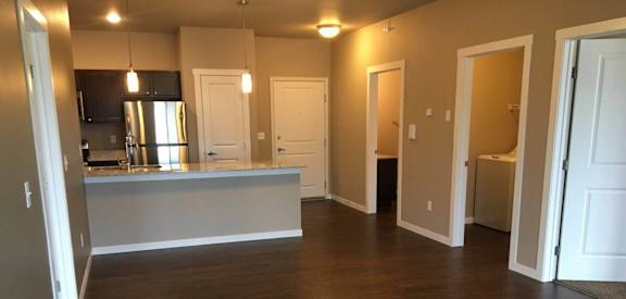 a contemporary living room with a kitchen  at Courtyard Apartments, Moorhead, MN