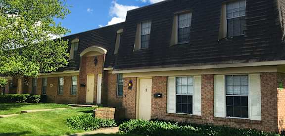 the front of a brick house with white shutters and a lawn  at Forest Park Apartments, Ohio, 45240