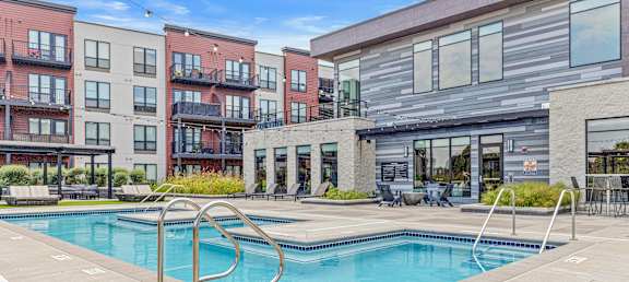 A swimming pool surrounded by apartment buildings.