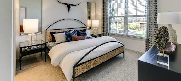 a bedroom with a large bed and a ceiling fan