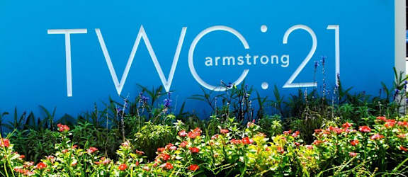 the amaz logo on a blue wall with flowers