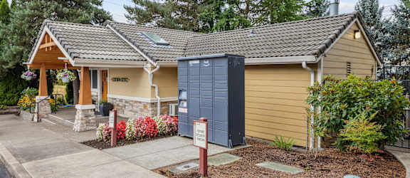 a small yellow house with a blue mailbox in front of it