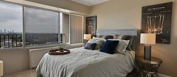 a bedroom with a bed and a large window at CityView on Meridian, 3801 N. Meridian St, Indianapolis, IN 46208