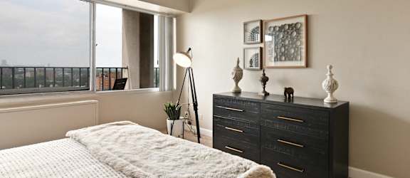 a bedroom with a bed and a large window at CityView on Meridian, 3801 N. Meridian St, Indianapolis, IN 46208