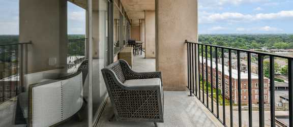 a balcony with wicker chairs and a view of the city at CityView on Meridian, 3801 N. Meridian St, Indianapolis, IN 46208