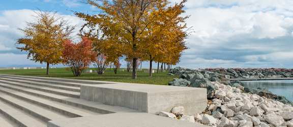 Image of concrete steps, with tree and Lake Michigan in the background at Eden Commons, Chicago, IL