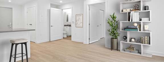 a living room with white walls and a wooden floor