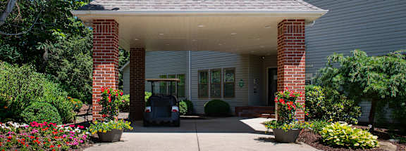 a house with a lawnmower parked in front of itat Monroeville Apartments, Pennslyvania, 15146