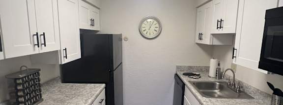 a kitchen with white cabinets and a black stove top ovenat Monroeville Apartments, Pennslyvania, 15146