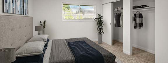 a bedroom with a bed and closet and a window