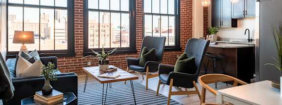 a living room with a couch chairs and a table