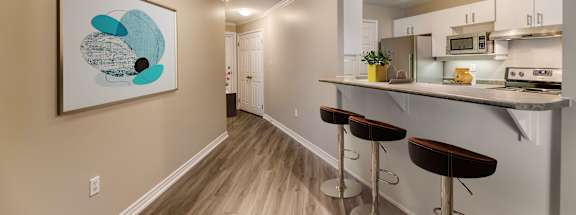 a kitchen with a breakfast bar and stools