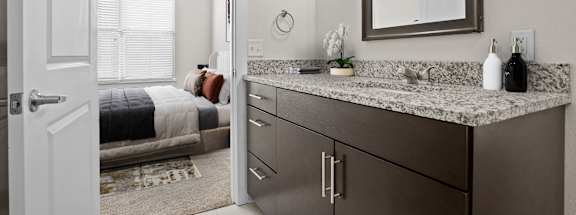 A bathroom with a vanity and a mirror.