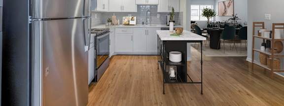 a kitchen with white cabinets and stainless steel appliances