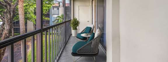 a balcony with two chairs and a table