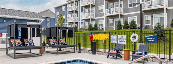 our apartments have a swimming pool and aenced in area with chairs