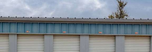 A row of grey garage doors are closed.