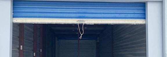 A storage unit numbered 42 with a blue roller shutter door.