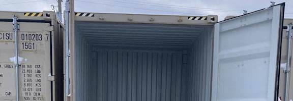 A shipping container is open and empty.
