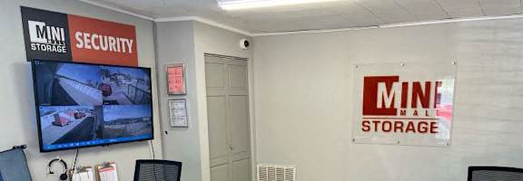 A storage office with a security sign on the wall.